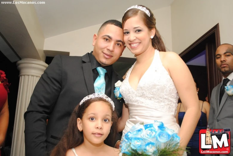 two people standing side by side in a room with flowers