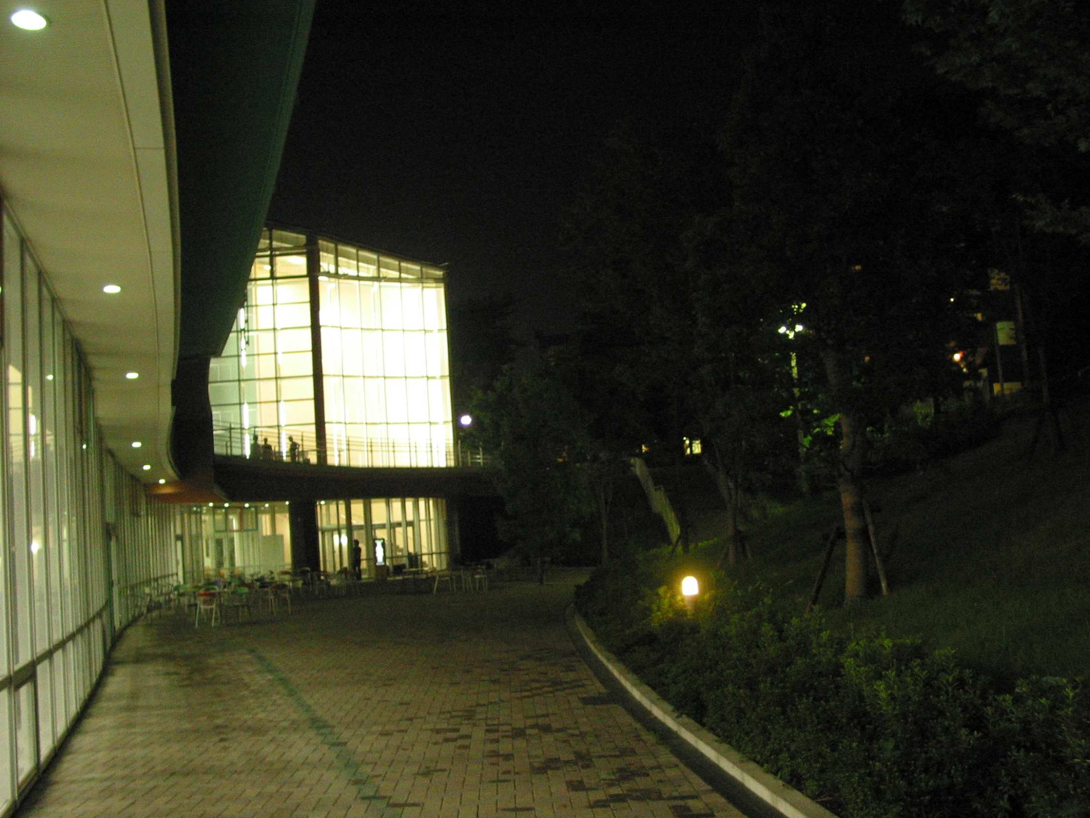 a building at night with a light shining on the side