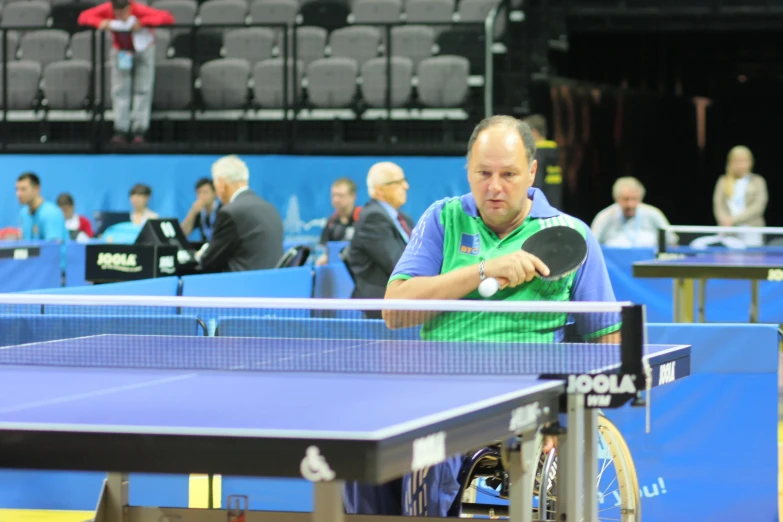 a person that is playing in a game of table tennis