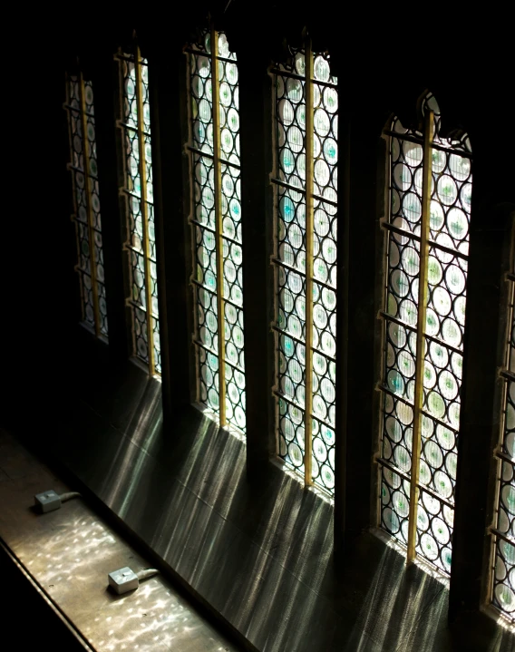 four stained glass windows are set in the room