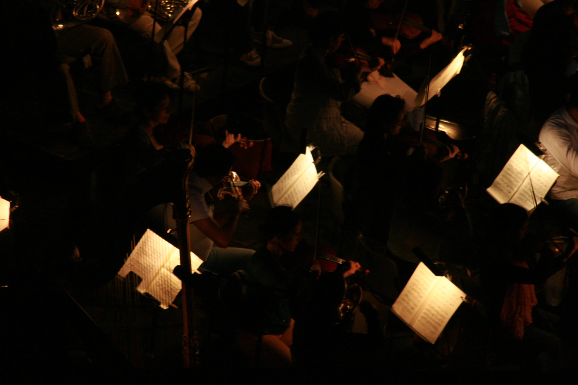 a group of people playing musical with lights shining on them