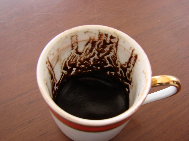 there is soing dark in the top of a coffee cup