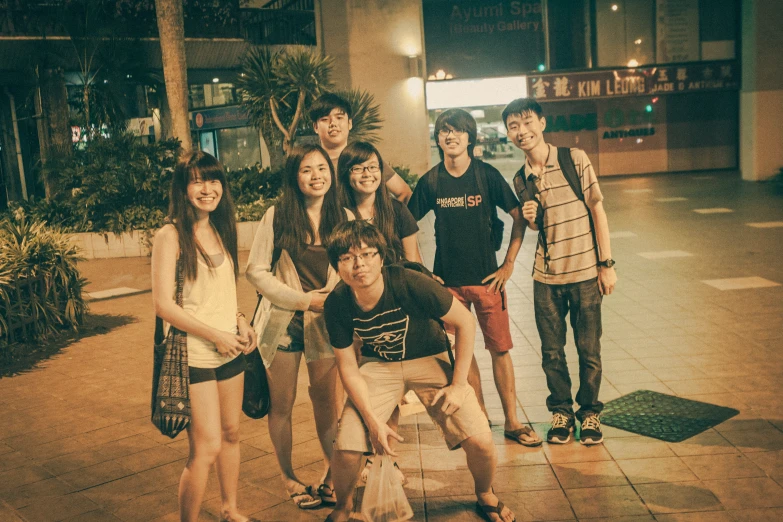 a group of s posing on the street