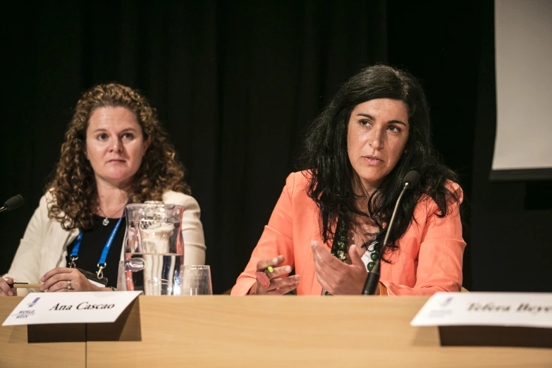 two women in discussion sitting at a table