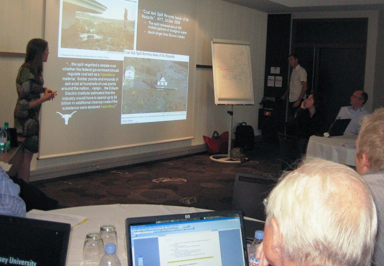 a group of people are in front of a projector screen