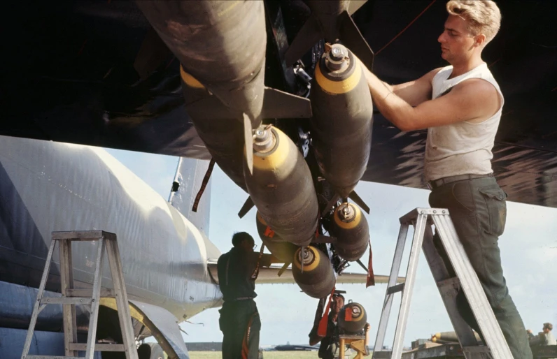 two men working on an airplane engine