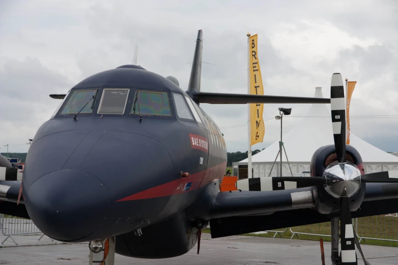 an airplane parked on the pavement in front of a building