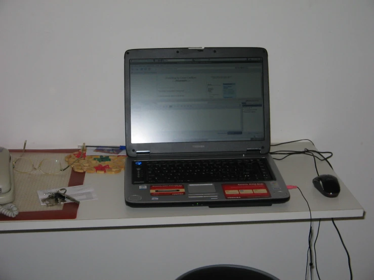 a lap top computer sitting on a desk with headphones