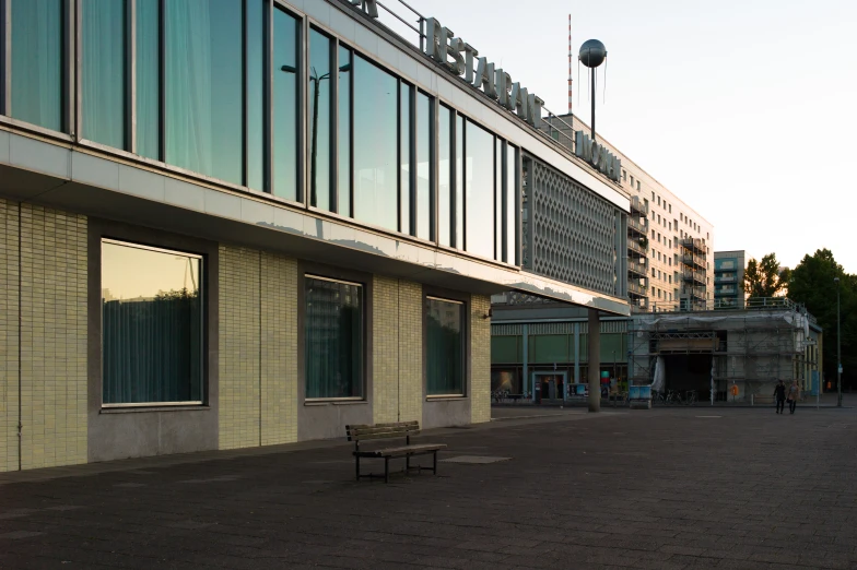 the bench is empty beside the tall building