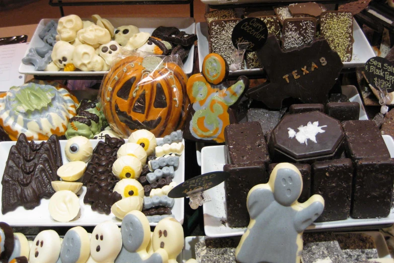 some halloween sweets are on display in small containers