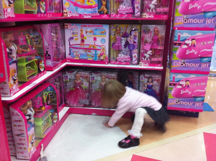 this is a little girl playing with toys at a store