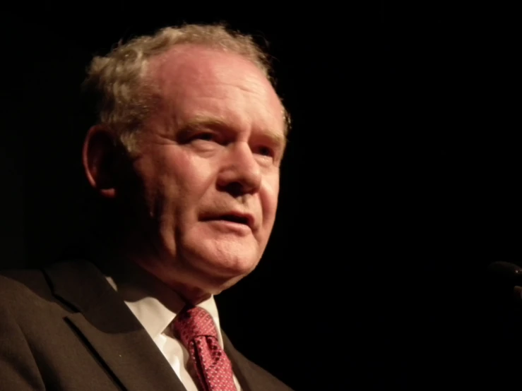 a man in a suit and red tie