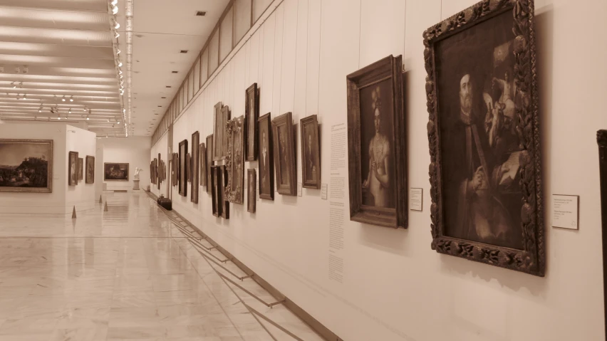 two people standing in the hallway between the pictures