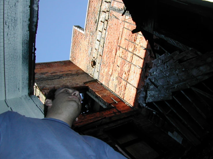 a man that is standing up and looking up