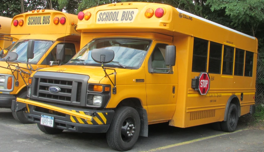 three yellow school buses parked in the parking lot