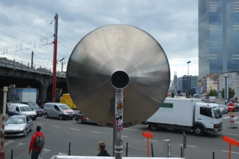 a metal object with a lot of traffic behind it