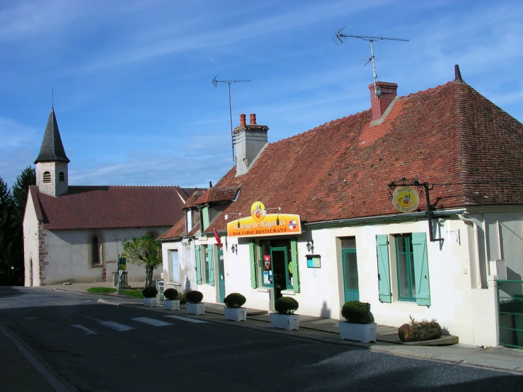 a town has small white buildings with blue shutters