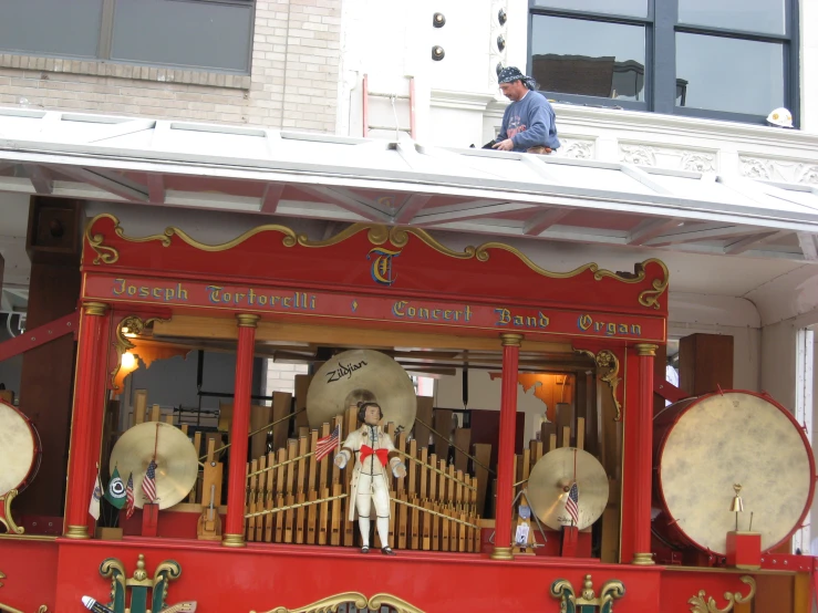 an old style red organ with bells on it