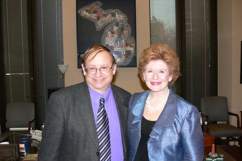 a woman standing next to a man in a suit and tie