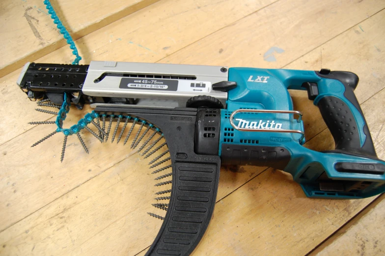 a makita drill, on top of a wooden table