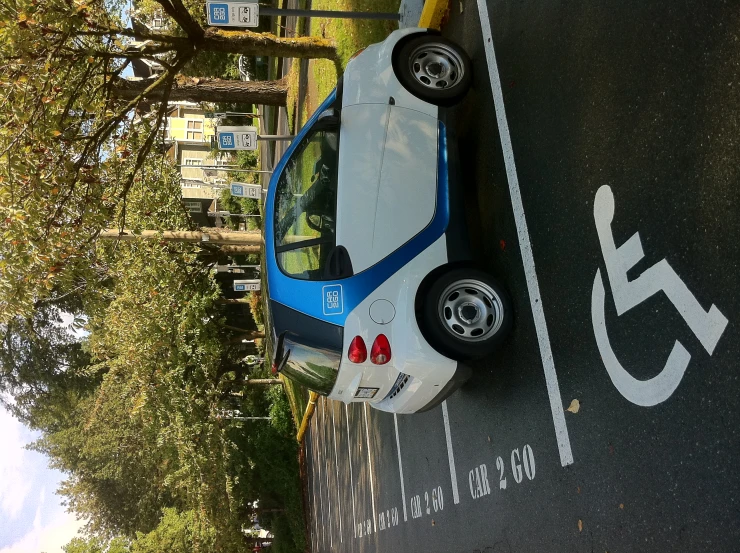 an electric car plugged in to the side of a street