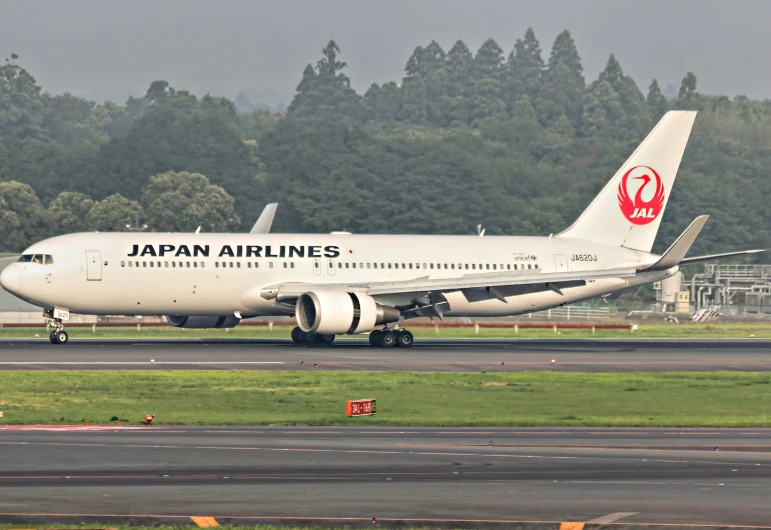 a japan airlines airplane is sitting at an airport