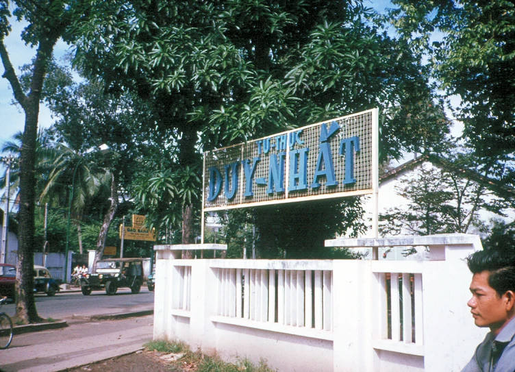 a man looking at the side of a building with a sign that reads miami