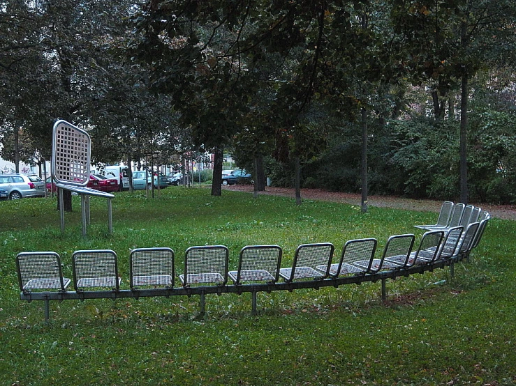 a curved circular bench near a sign in a park