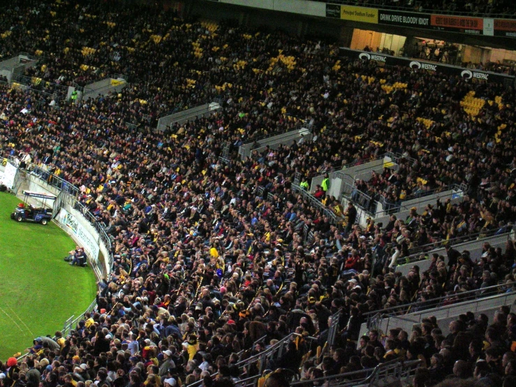 a stadium full of people at a game with a crowd watching