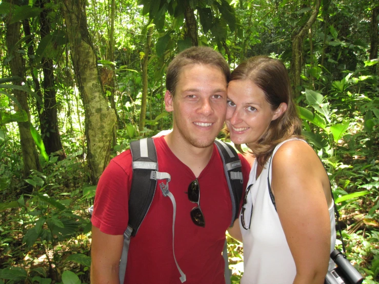 the couple is taking a selfie in the woods