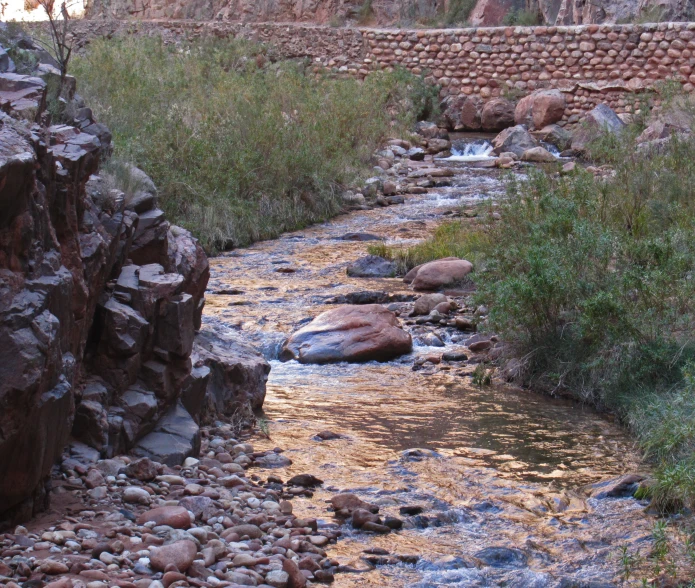 a stream in a rocky canyon that flows through