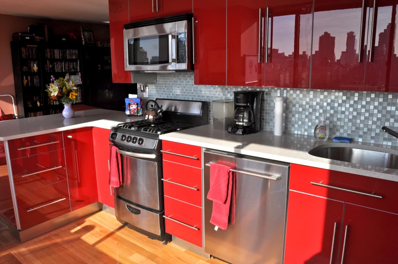 kitchen with large stainless steel dishwasher and red cabinets