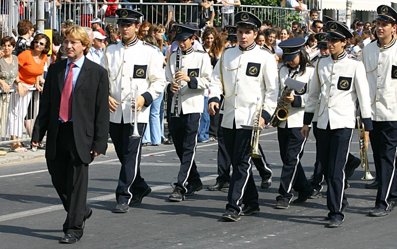 two men and a woman are marching in a parade