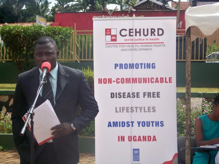 a man in a suit speaking into a microphone