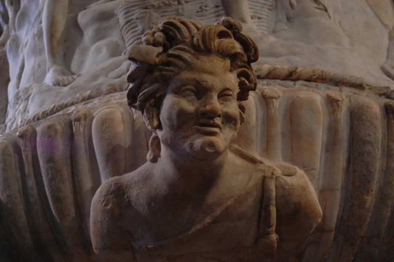 ancient carving of a bearded man's head on display