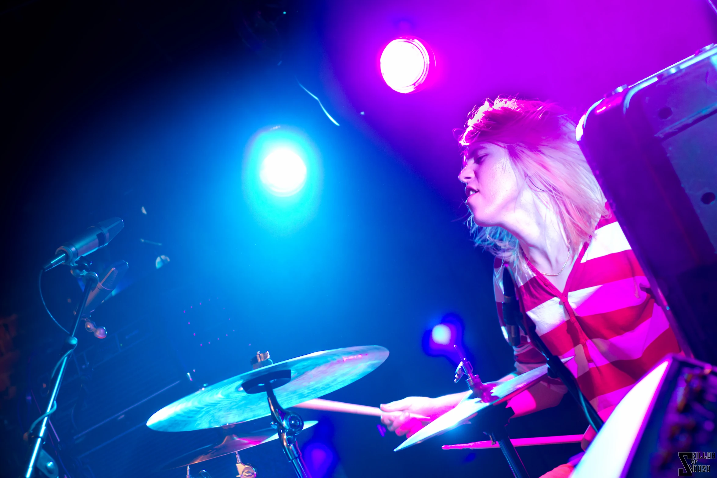 a young lady that is playing the drums in her hand