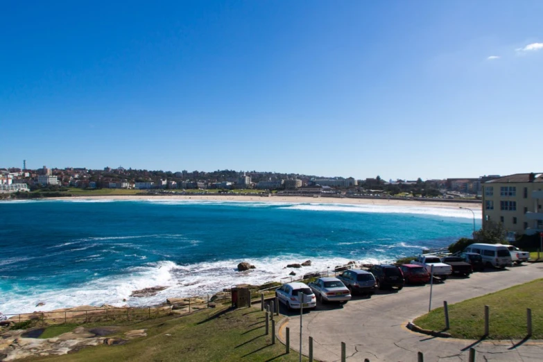 the blue water and sandy beach are seen from an angle