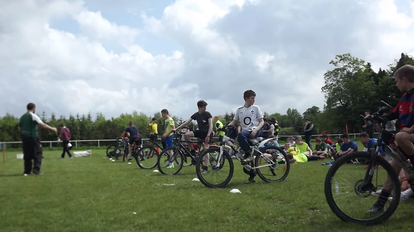 group of men sitting on bicycles standing next to each other