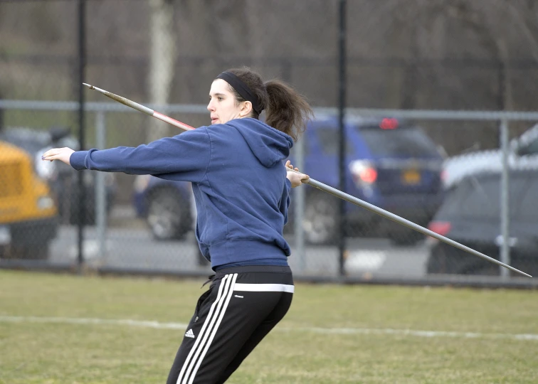 a woman is swinging a tennis racket on the field