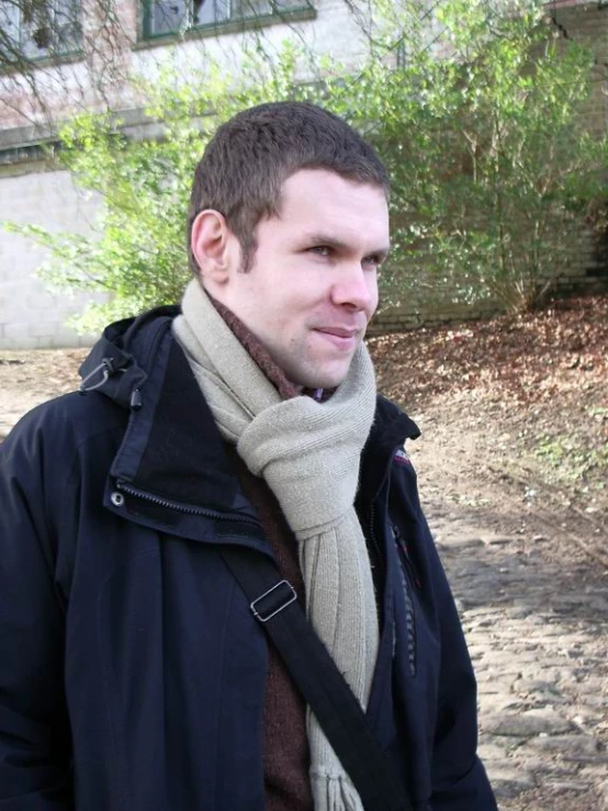 a man that is wearing a scarf and jacket