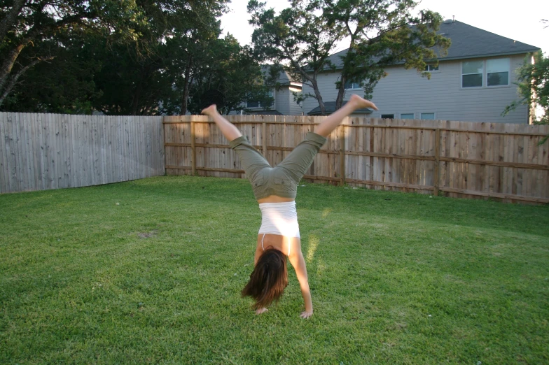 a woman is standing on one leg while stretching her body