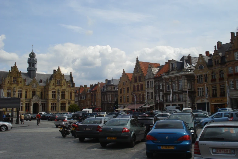 a city filled with parked cars on top of a street