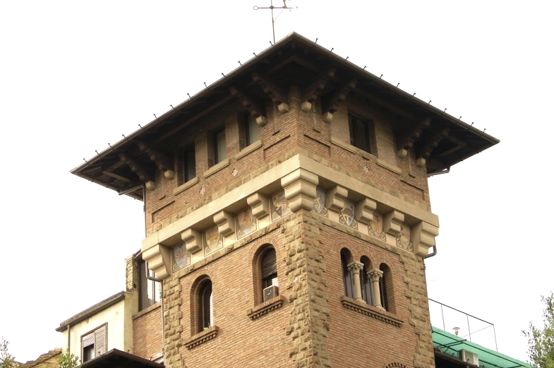 the clock on the top of a brick tower