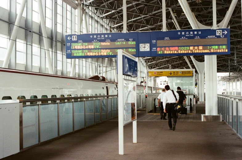 a man that is walking down a hallway with luggage