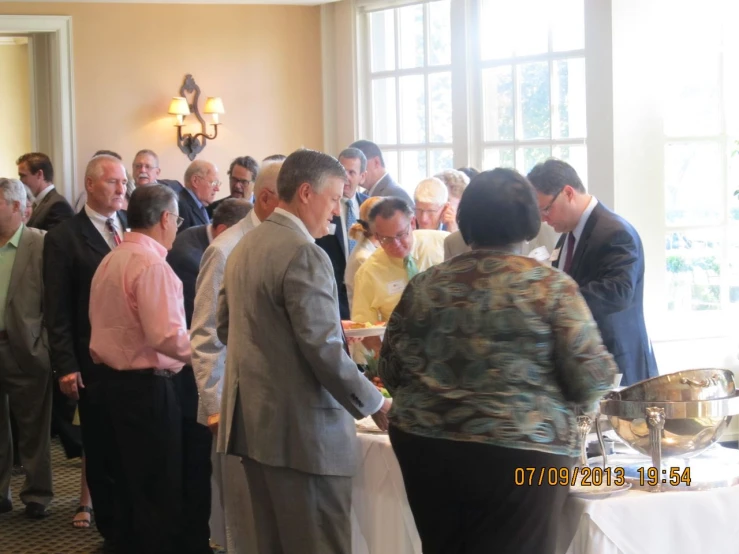 a group of people are gathering to eat some food