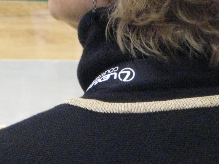 a close up of a person wearing a black shirt and hat