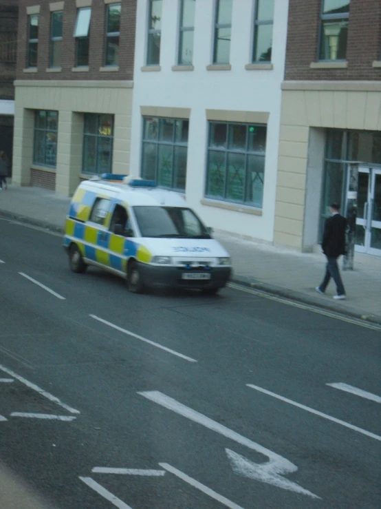 an ambulance on the road in front of a building