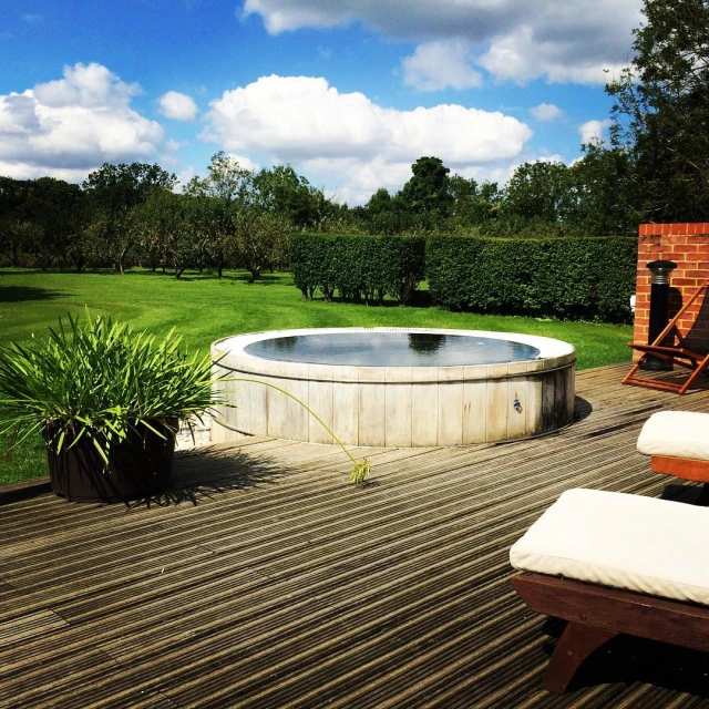 a round bathtub sitting on top of a wooden deck