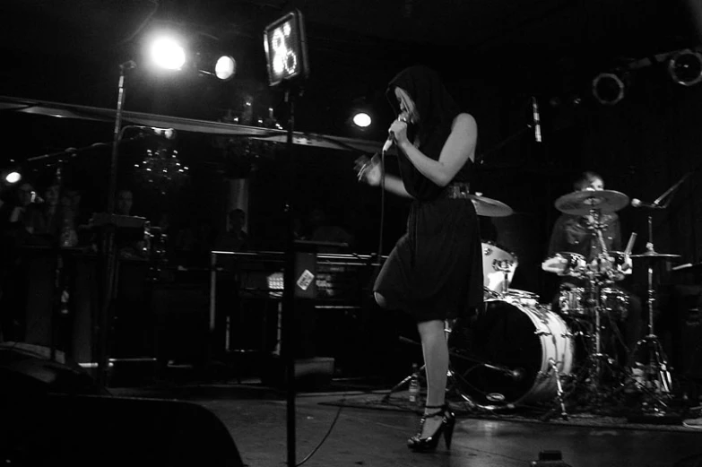 a woman on stage with her legs crossed