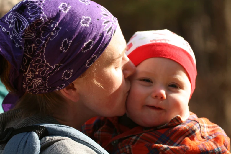 a woman is holding a small baby in her arms